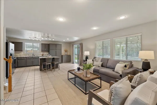a living room with furniture and view of kitchen