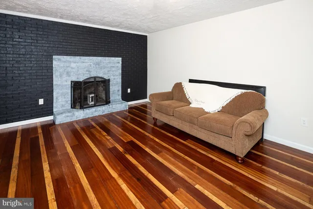a living room with a couch and a fireplace