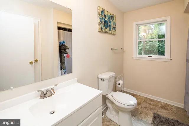 a white toilet sitting next to a bathroom sink