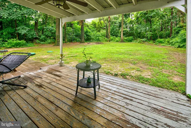 a view of a wooden deck with a yard