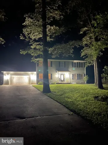 a view of a house with a yard and garage