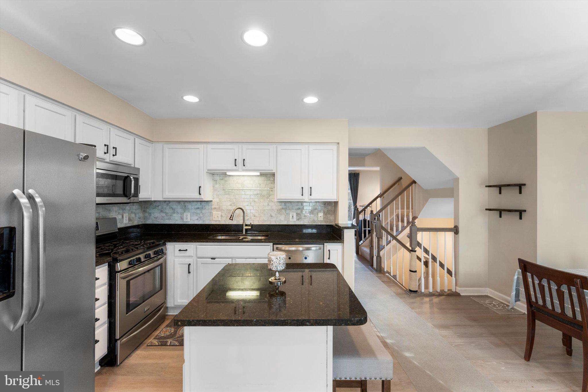 163 Shirley Square Southeast Leesburg, VA 20175 - Photo 12 of 45 a kitchen with stainless steel appliances granite countertop a sink a stove a refrigerator and a cabinets