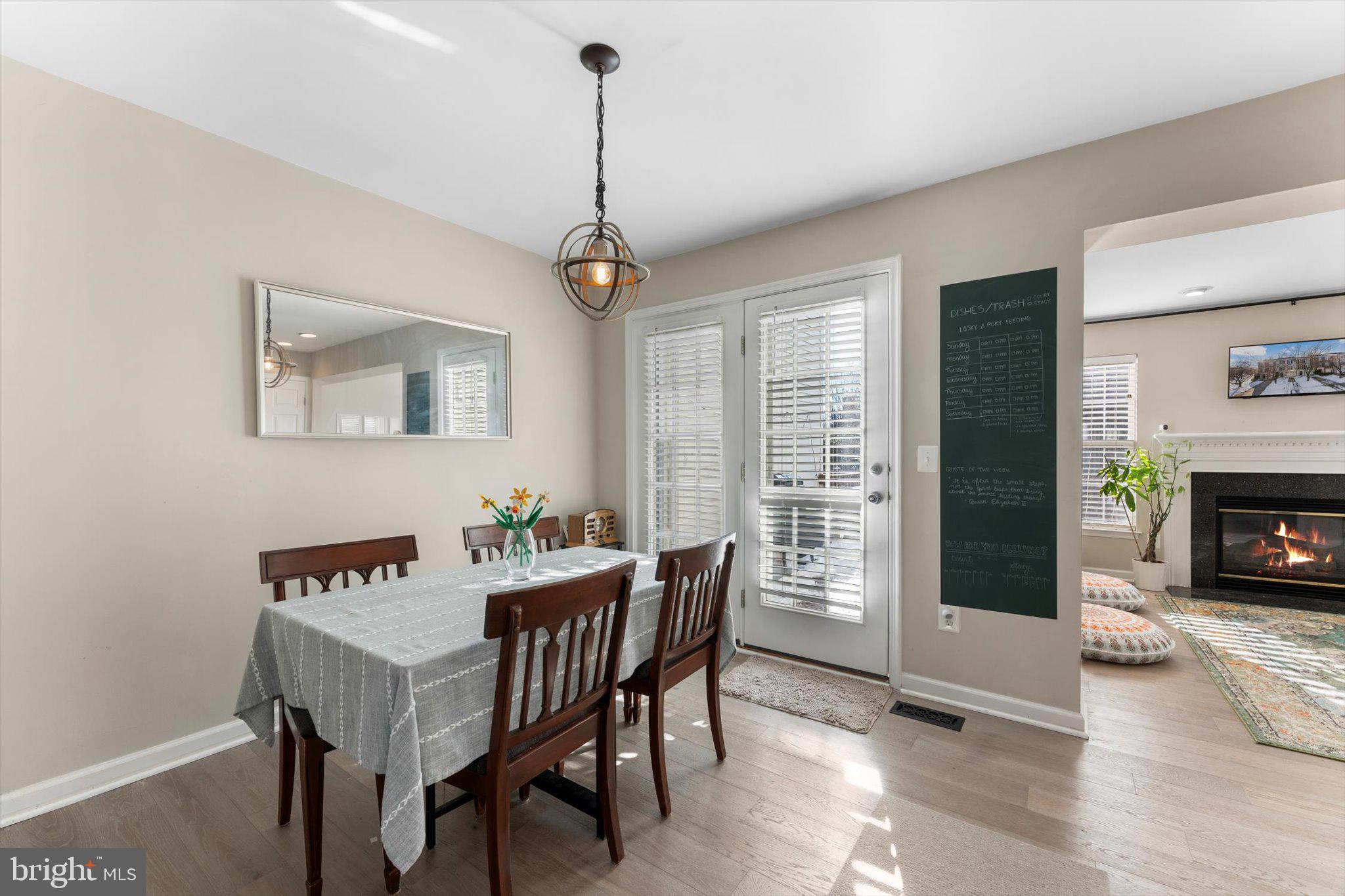 163 Shirley Square Southeast Leesburg, VA 20175 - Photo 14 of 45 a view of a dining room with furniture window and wooden floor