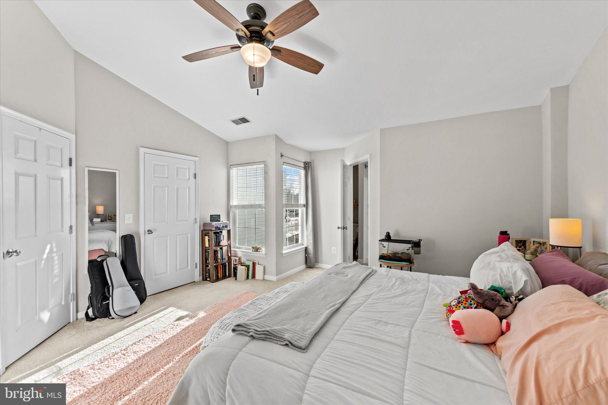 163 Shirley Square Southeast Leesburg, VA 20175 - Photo 26 of 45 a bedroom with a bed and a chandelier