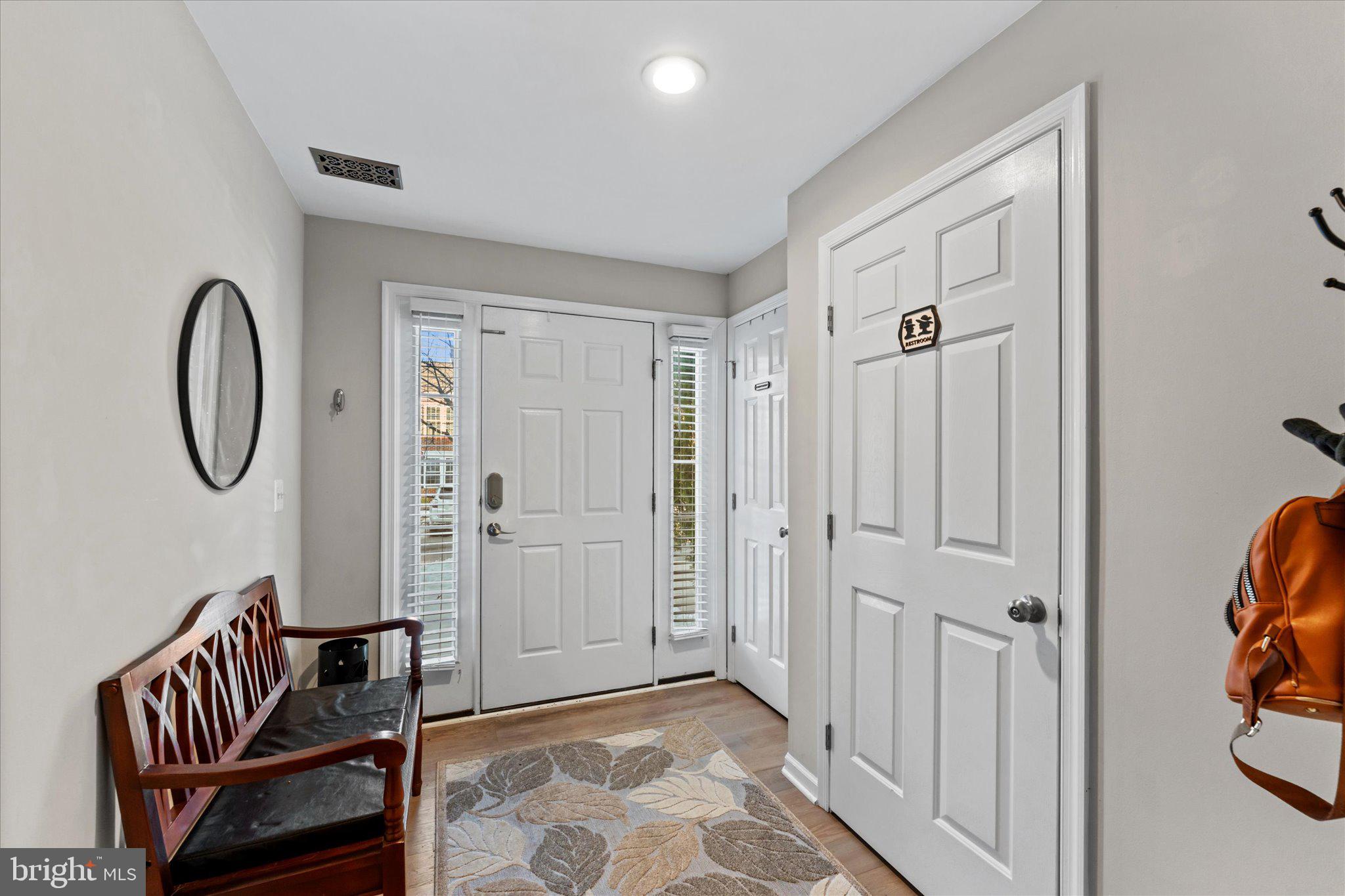 163 Shirley Square Southeast Leesburg, VA 20175 - Photo 3 of 45 a view of a hallway with entryway wooden floor and front door