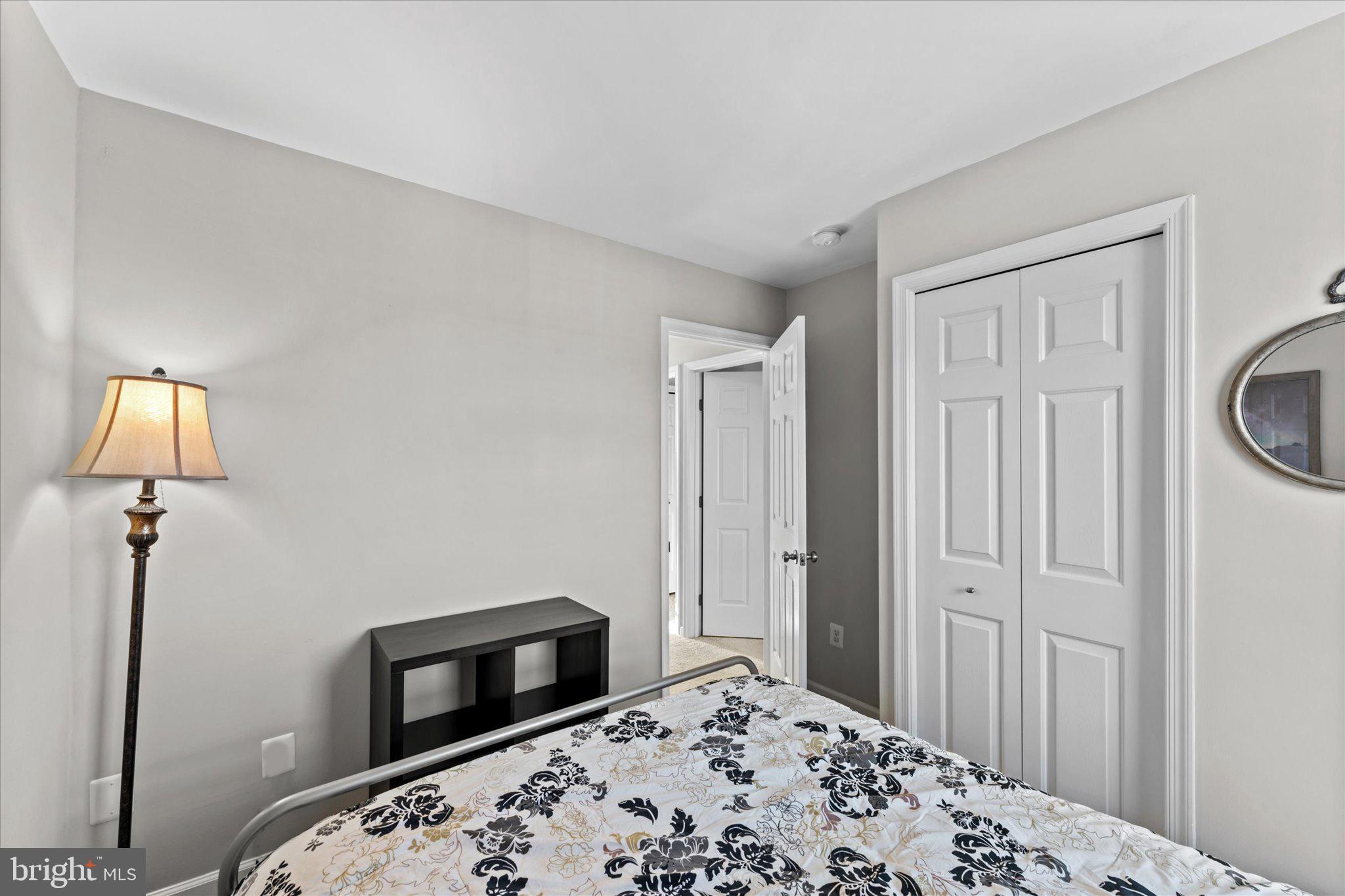 163 Shirley Square Southeast Leesburg, VA 20175 - Photo 31 of 45 a bedroom with a bed and a lamp