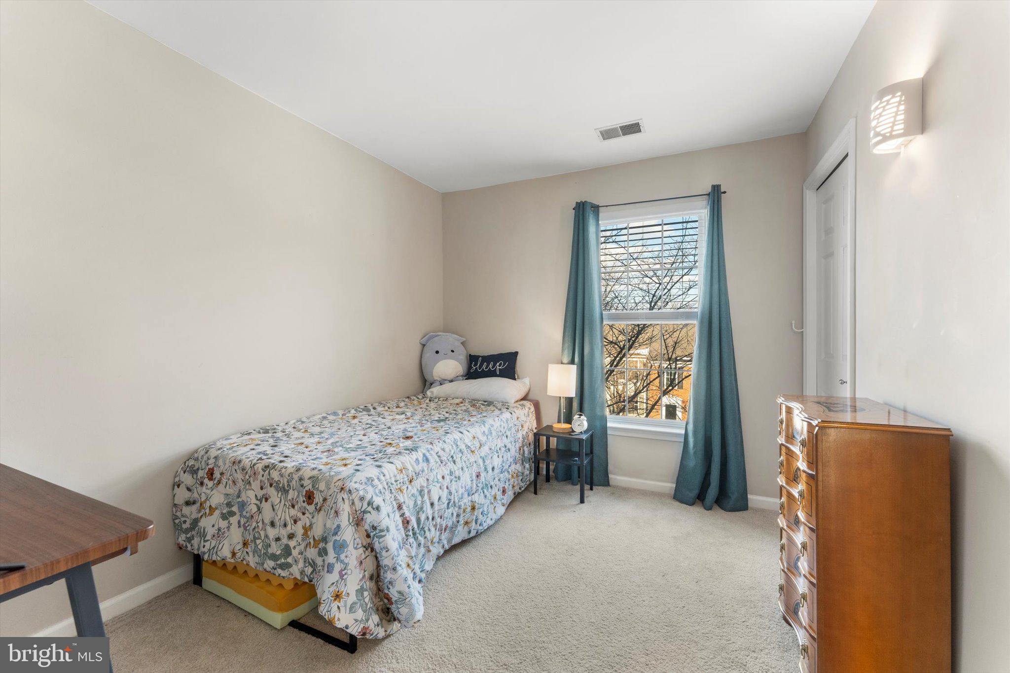 163 Shirley Square Southeast Leesburg, VA 20175 - Photo 32 of 45 a bedroom with a bed and a window