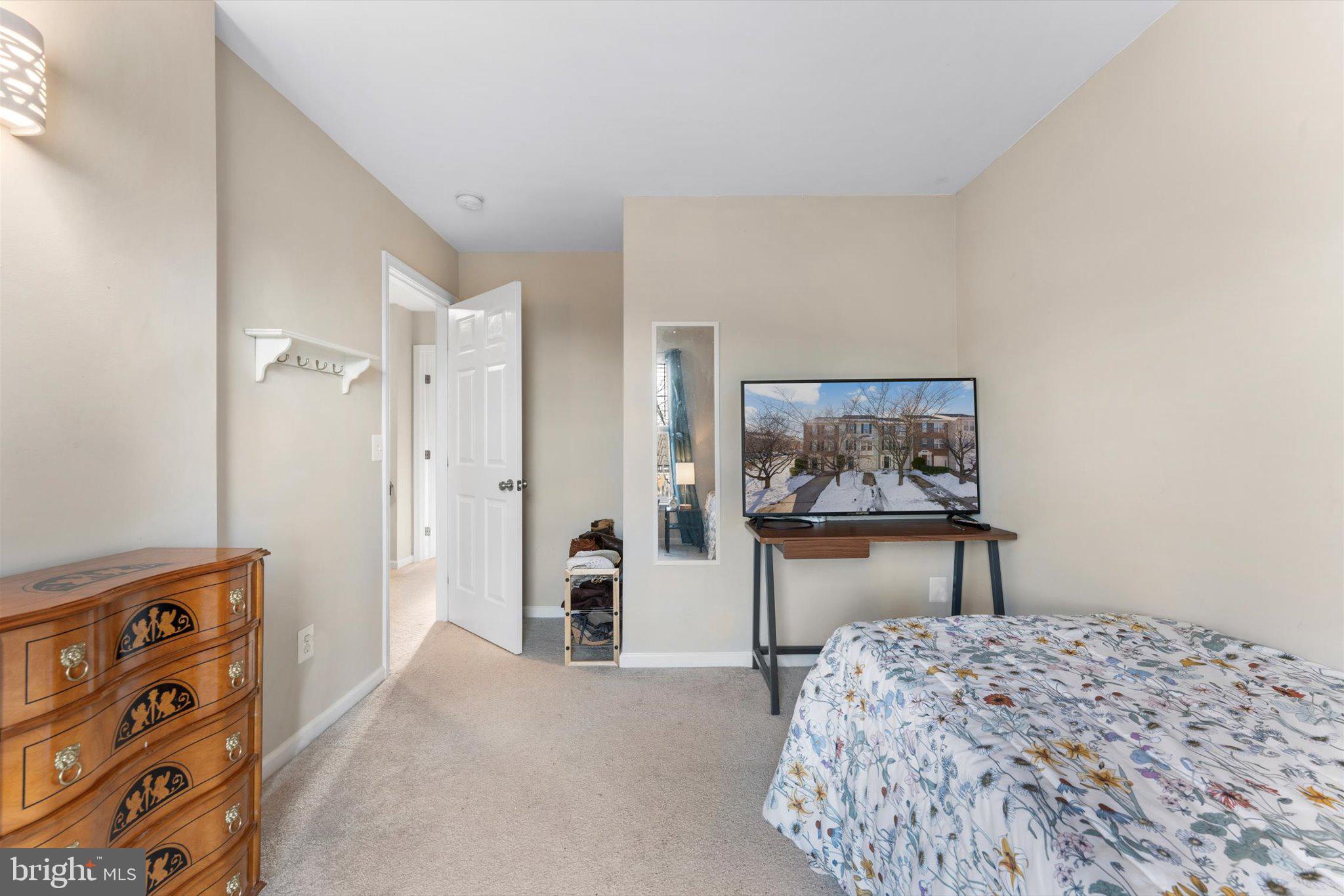 163 Shirley Square Southeast Leesburg, VA 20175 - Photo 33 of 45 a bedroom with a bed and a dresser in it