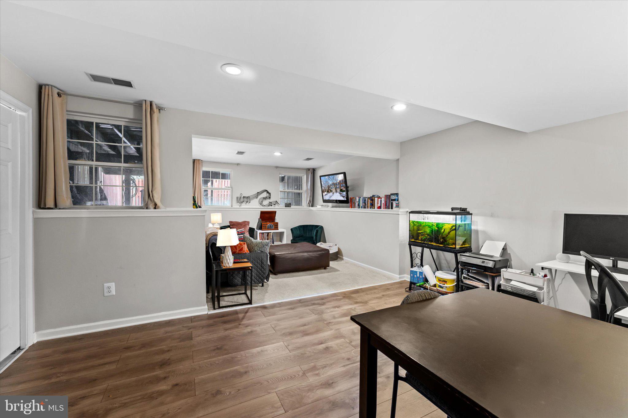 163 Shirley Square Southeast Leesburg, VA 20175 - Photo 5 of 45 a living room with furniture and a flat screen tv with kitchen view