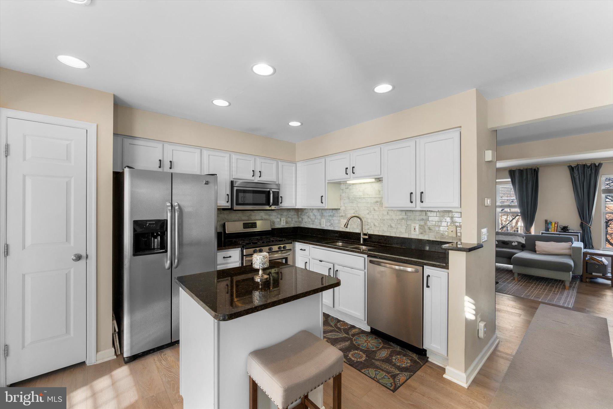 163 Shirley Square Southeast Leesburg, VA 20175 - Photo 10 of 45 a kitchen with granite countertop a sink stove and refrigerator