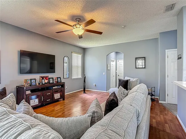 a living room with furniture and a kitchen