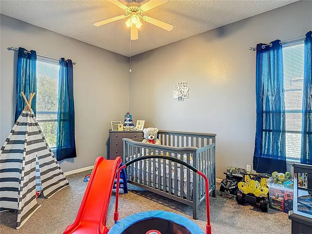 a bathroom with a granite countertop sink a toilet and shower curtain