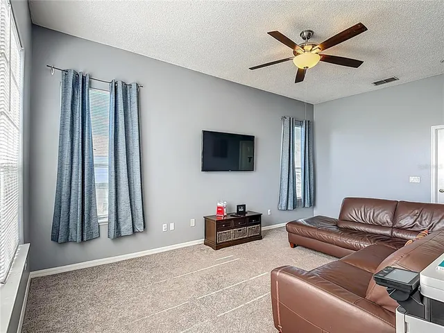 a bedroom with a bed and flat screen tv