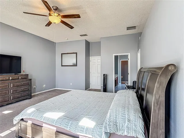 a white toilet sitting next to a white wall