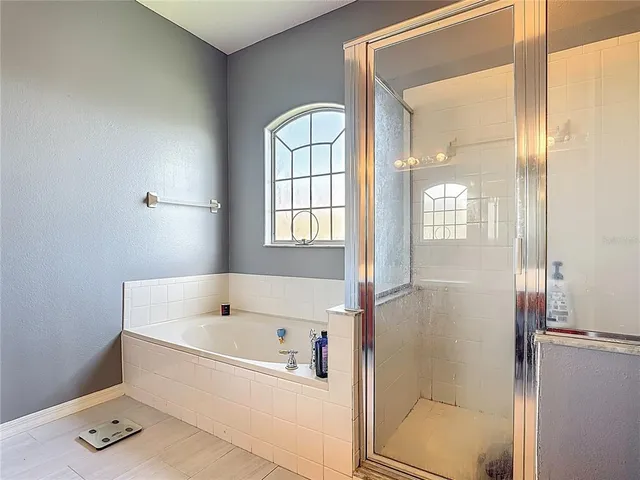 an aerial view of residential houses with outdoor space and lake view