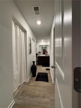 a view of walk in closet with clothes