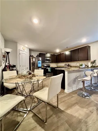 a living room with lots of furniture and kitchen view