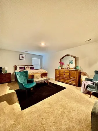 a living room with furniture and a book shelf