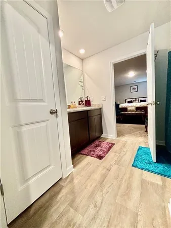 a view of a kitchen with kitchen island and stainless steel appliances