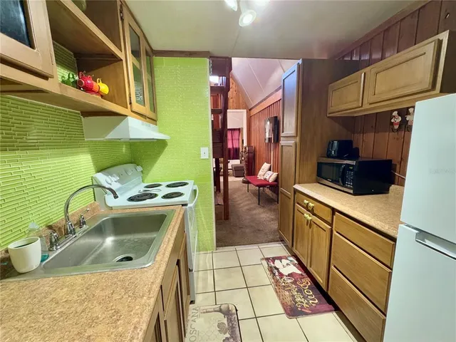 a kitchen with a sink a stove and cabinets