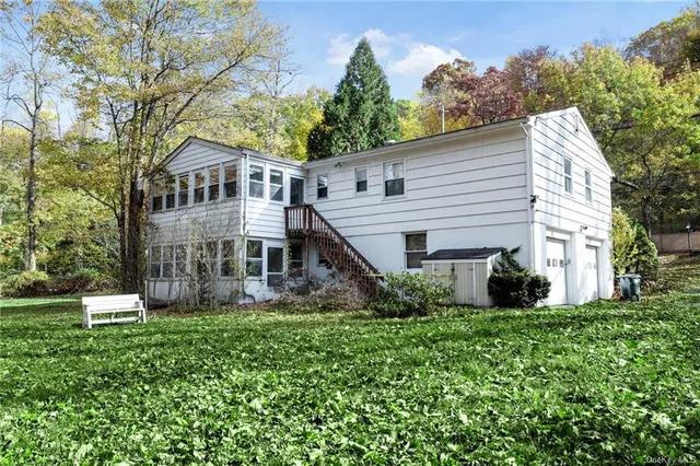 a view of a yard with plants and trees