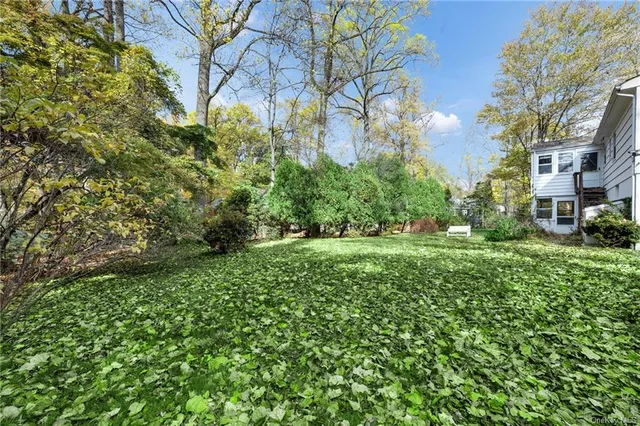 a view of a house with a yard and sitting area