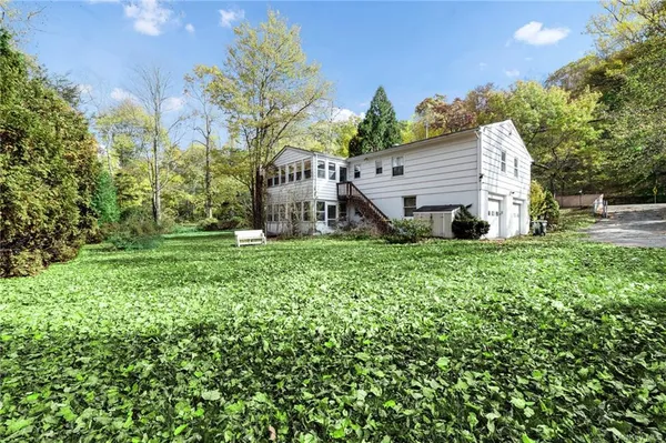 a view of green field with trees in the background