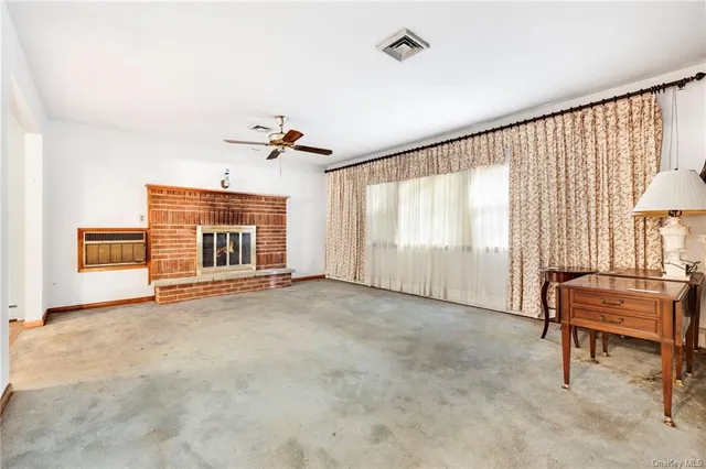 a view of an empty room with a fireplace