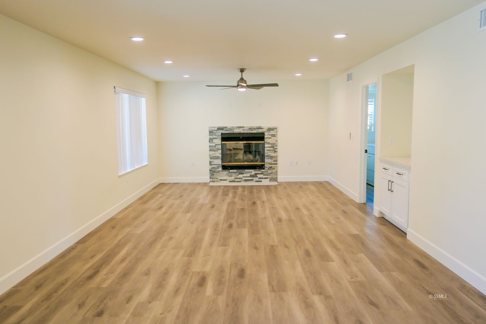 736 West Howell Avenue Ridgecrest, CA 93555 - Photo 8 of 50 an empty room with wooden floor ceiling fan and window