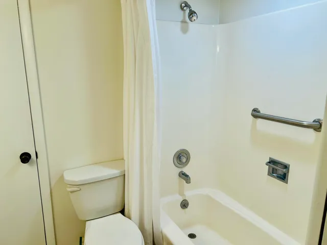 a white bath tub sitting next to a toilet