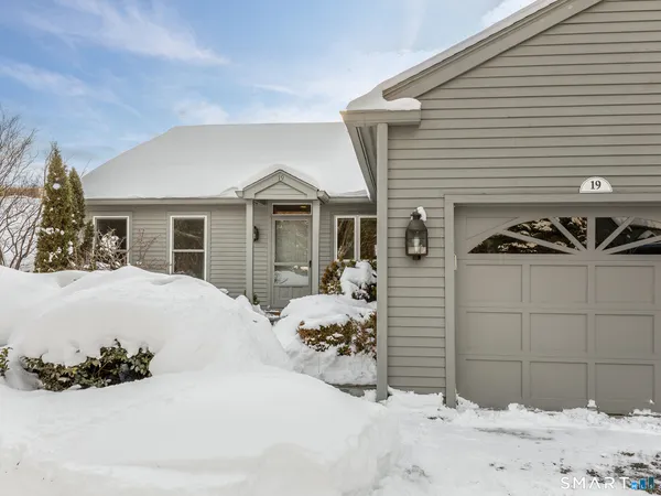 a view of a house with a snow on the road