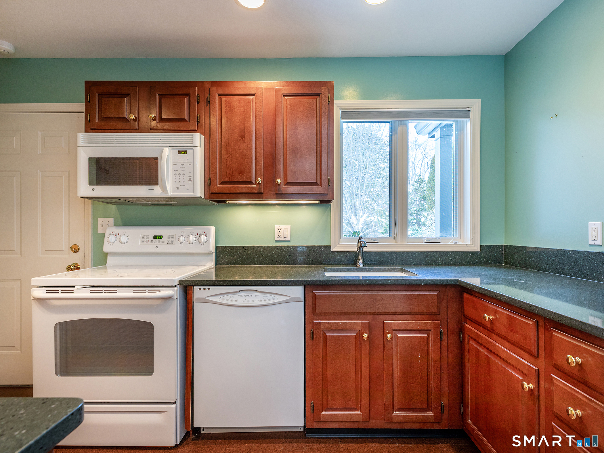 19 Juniper Meadow Road, Unit 19 Washington, CT 06794 - Photo 13 of 31 a kitchen with granite countertop a sink stove and cabinets
