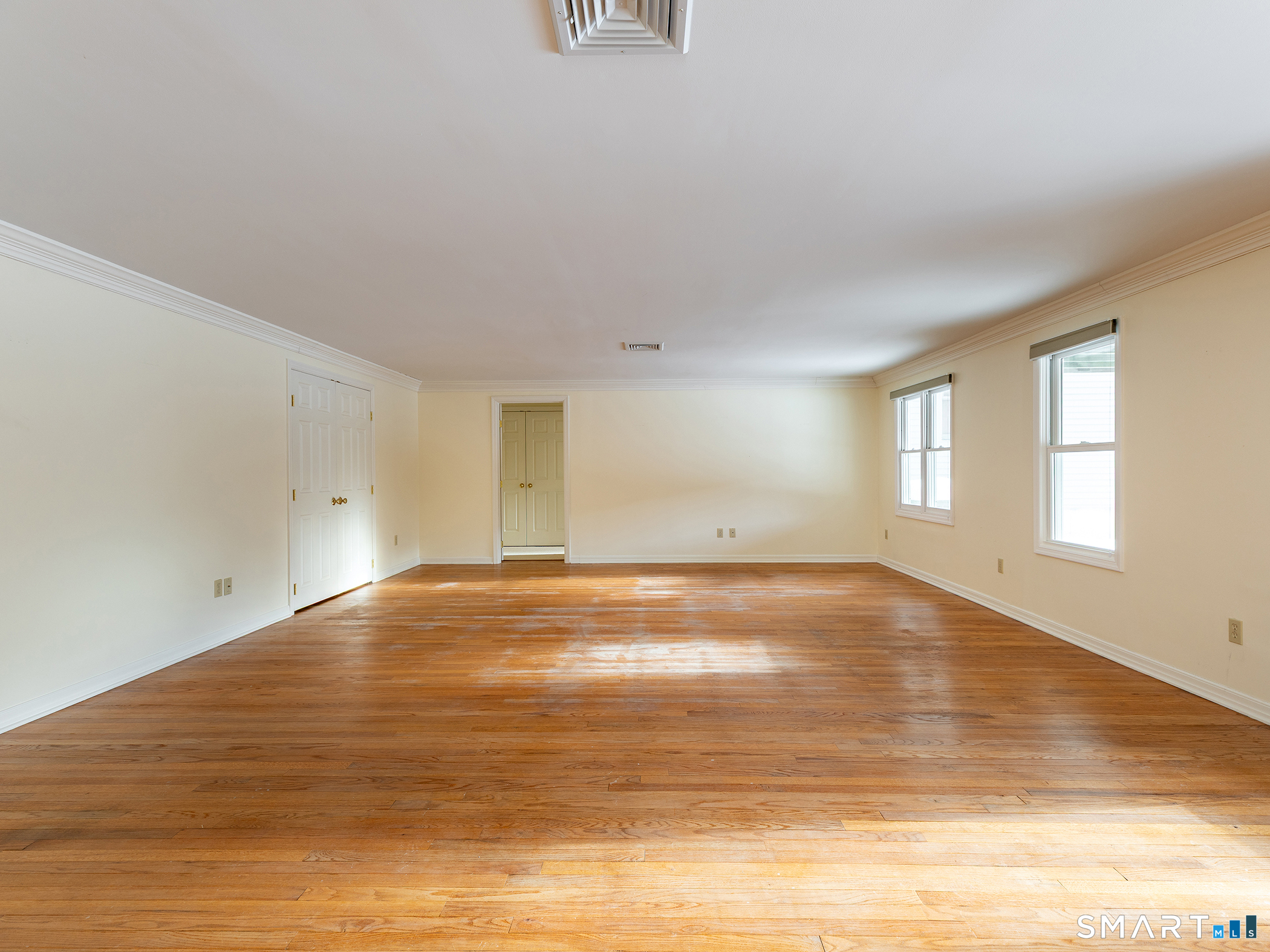 19 Juniper Meadow Road, Unit 19 Washington, CT 06794 - Photo 23 of 31 a view of empty room with wooden floor and fan