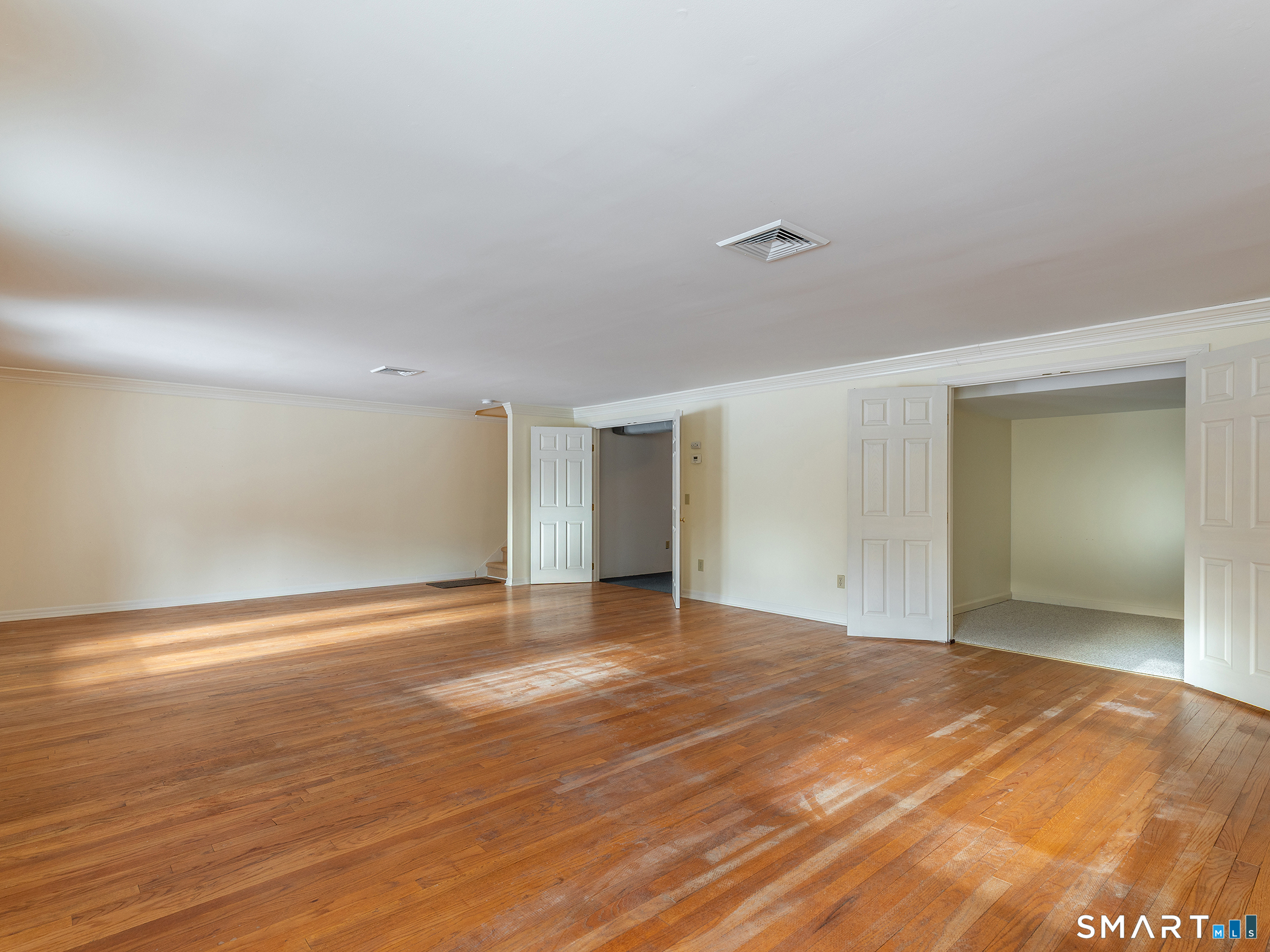 19 Juniper Meadow Road, Unit 19 Washington, CT 06794 - Photo 24 of 31 an empty room with wooden floor and windows