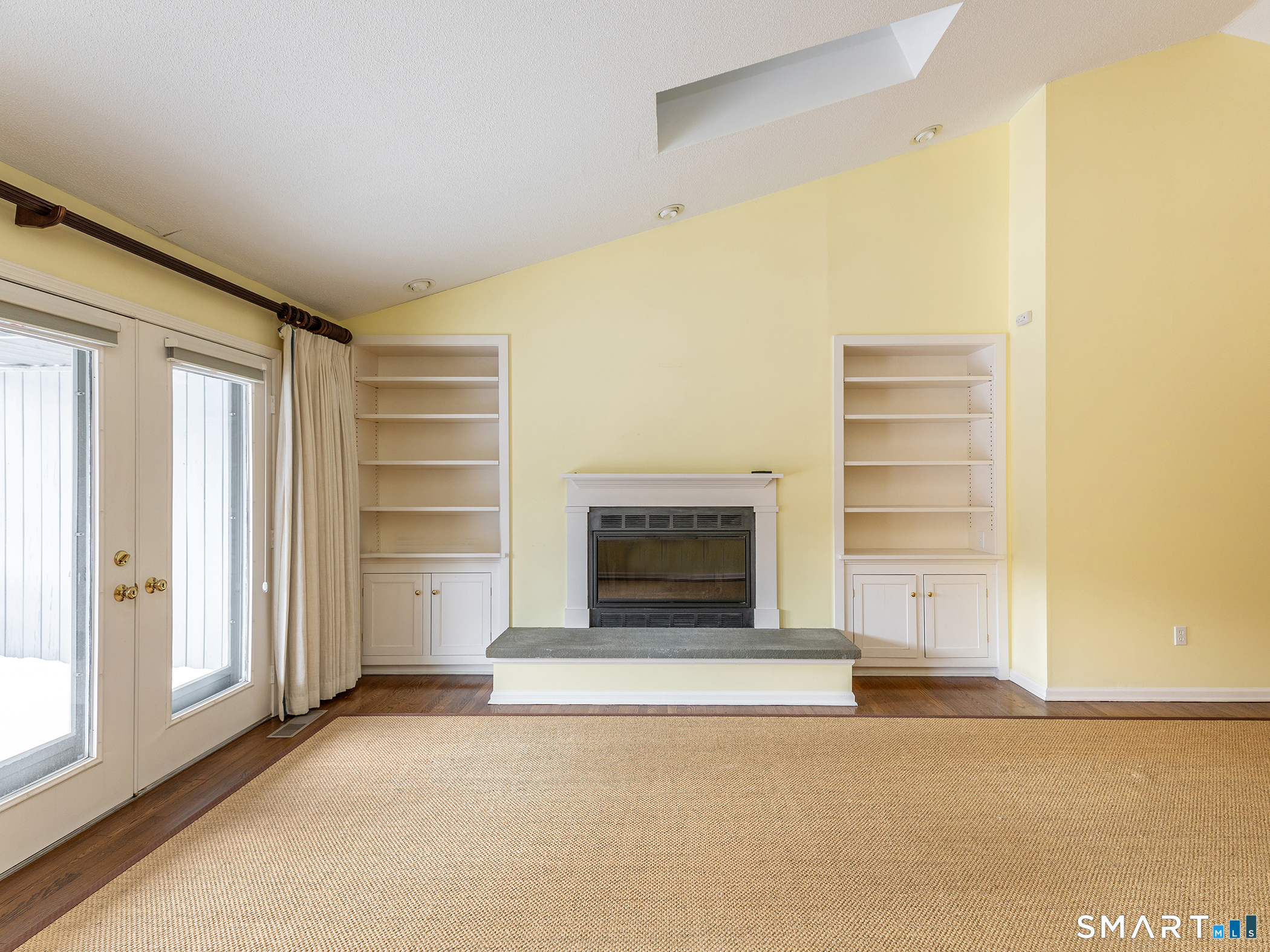 19 Juniper Meadow Road, Unit 19 Washington, CT 06794 - Photo 8 of 31 a view of an empty room with a fireplace and a window