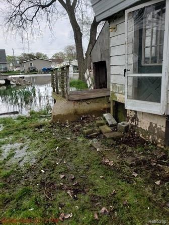 7345 Bealane Road Algonac, MI 48001 - Photo 16 of 16 deck, shed, and rear of subject showing neglect and high water table