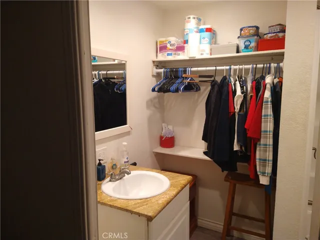 a bathroom with a toilet and a chair