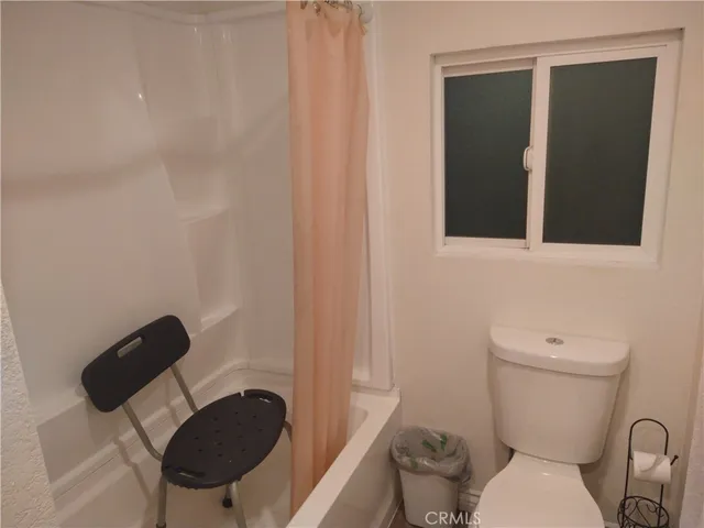 a view of a workspace room with wooden floor and chair