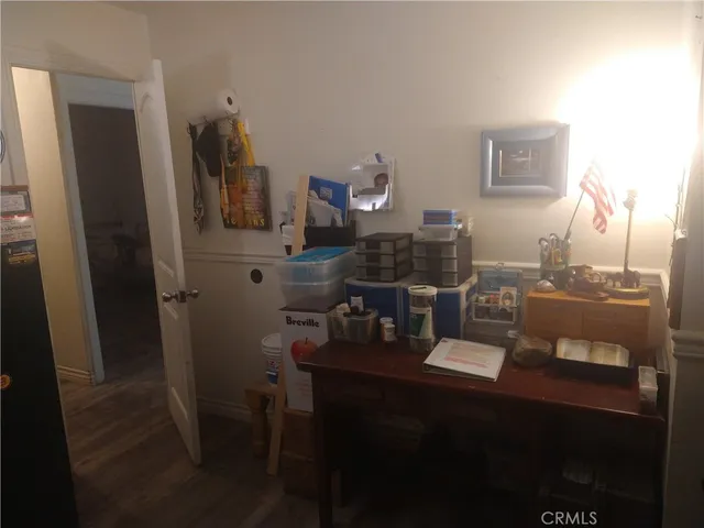 a bedroom with a bed and a wooden floor