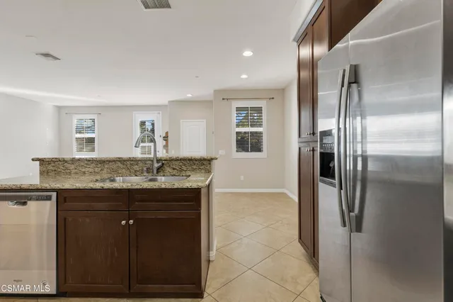 a bathroom with a granite countertop shower a sink and a mirror