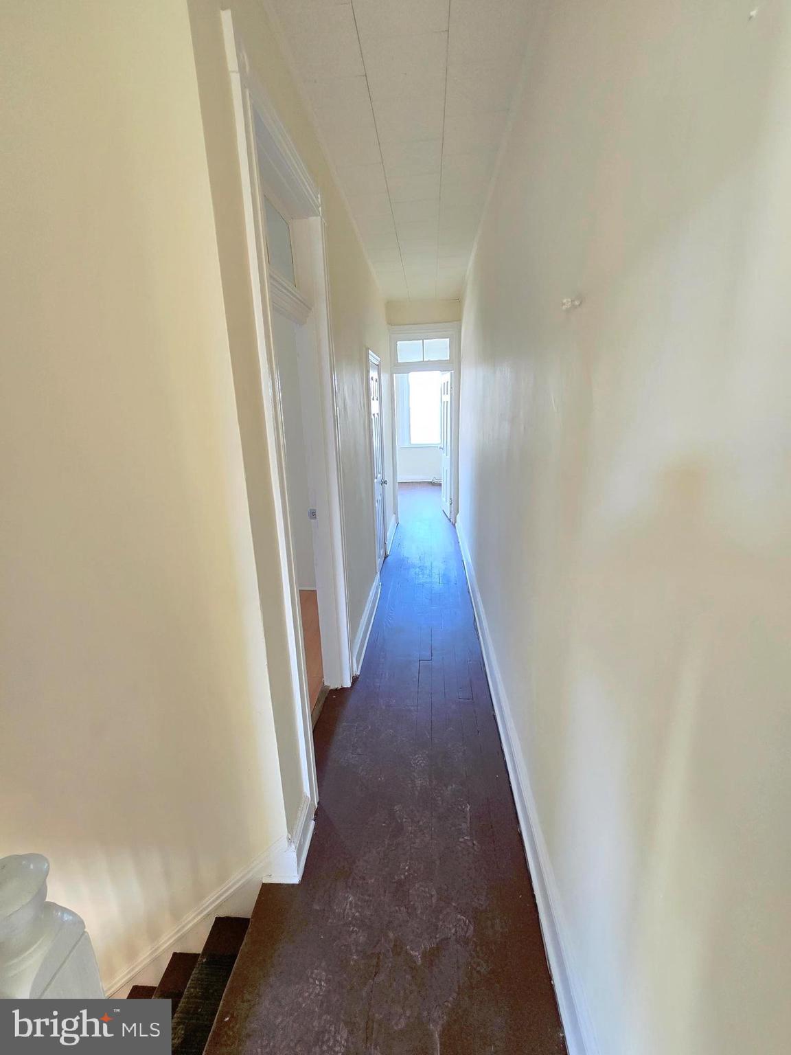 321 South Mount Street Baltimore, MD 21223 - Photo 13 of 20 a view of a hallway with wooden floor