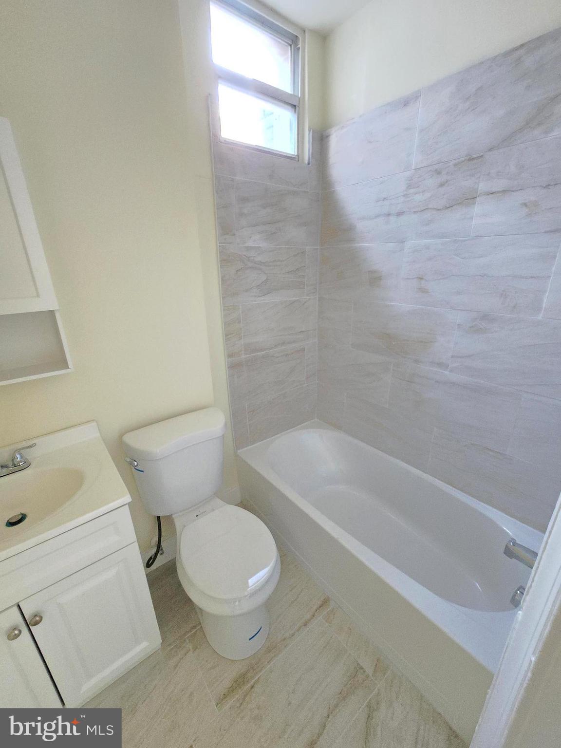 321 South Mount Street Baltimore, MD 21223 - Photo 17 of 20 a white toilet and tub sitting next to a bathroom sink