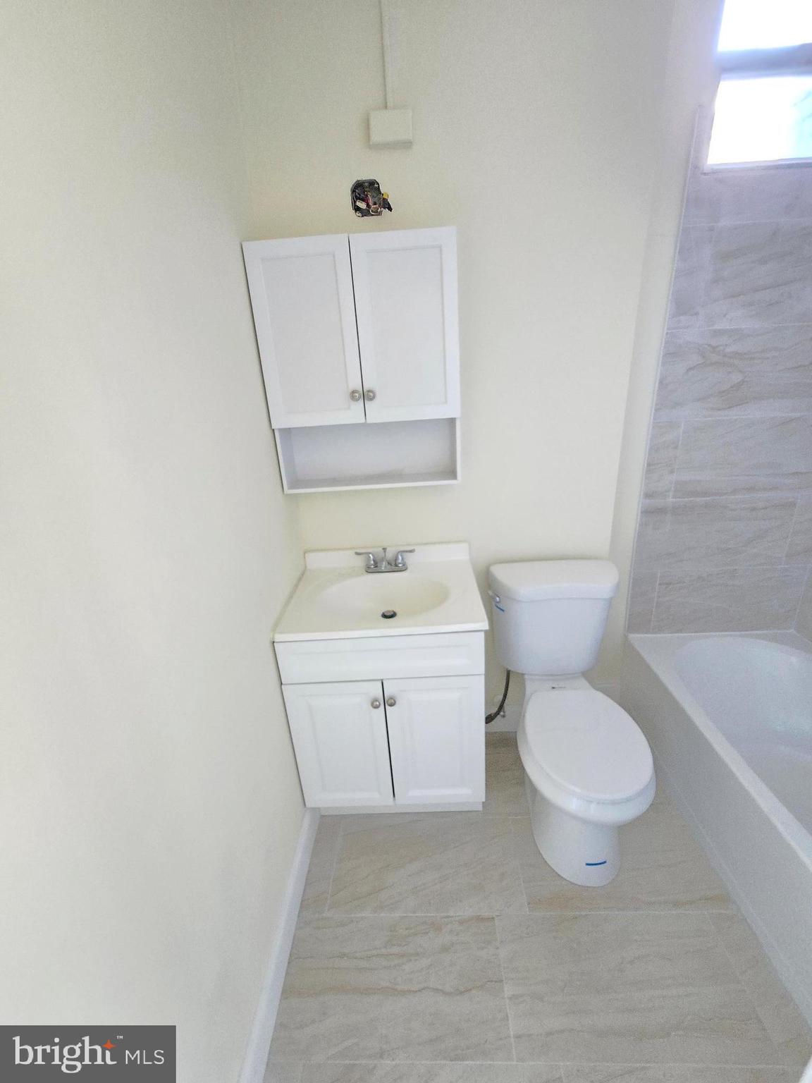 321 South Mount Street Baltimore, MD 21223 - Photo 18 of 20 a white toilet sitting next to a bathroom sink