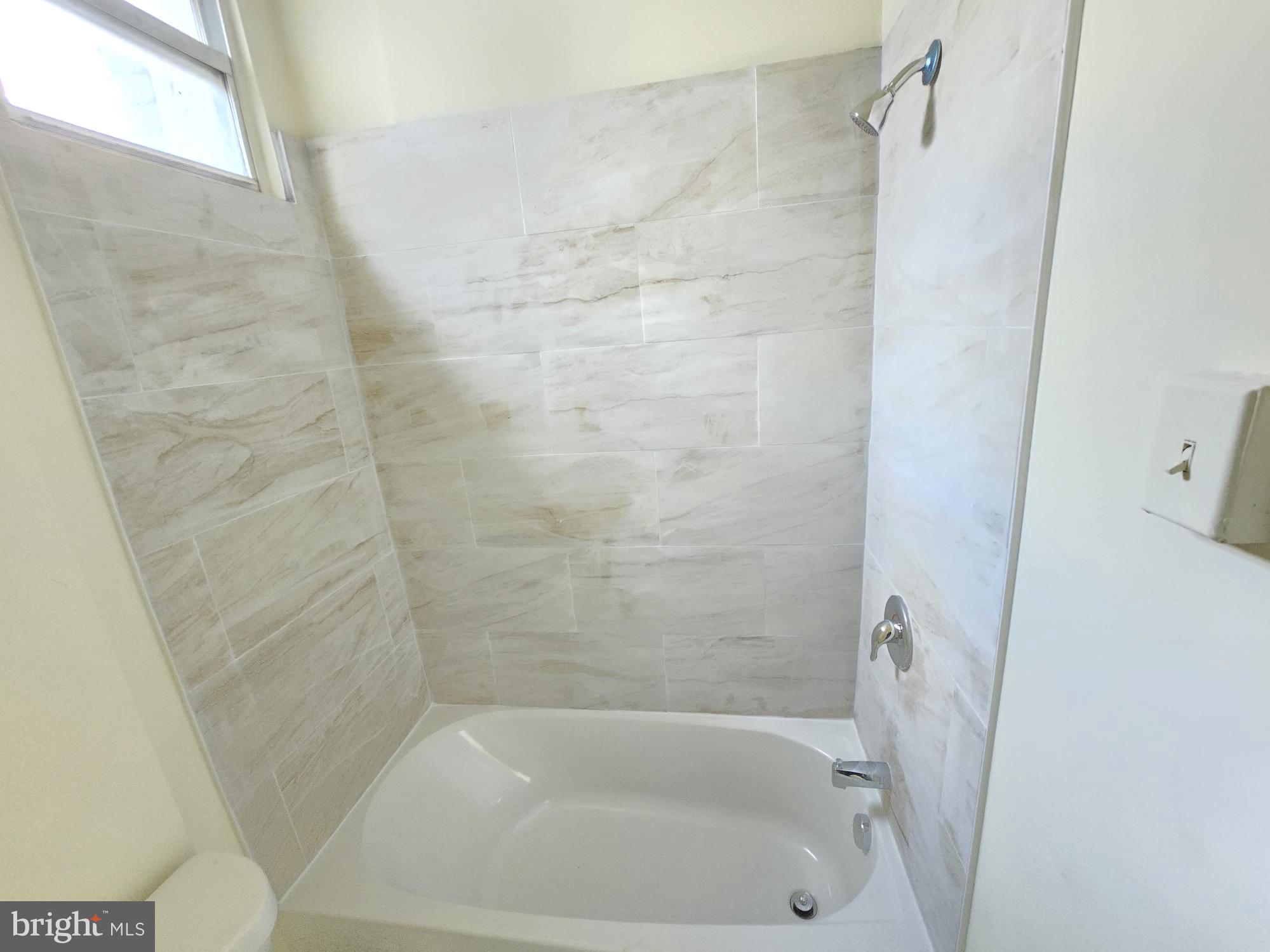 321 South Mount Street Baltimore, MD 21223 - Photo 20 of 20 a close up of a bathtub curtain