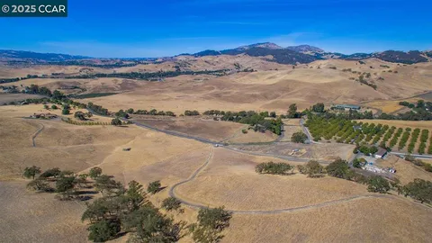 an aerial view of a houses with a ocean view