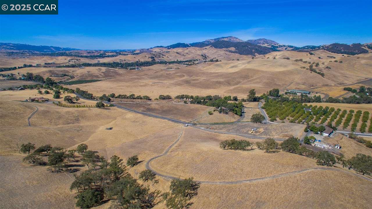 an aerial view of a houses with a ocean view