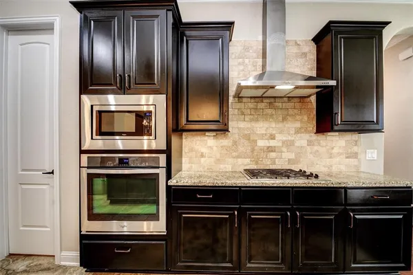 a kitchen with granite countertop stainless steel appliances and granite counter tops