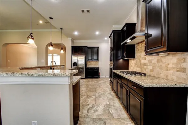 a open kitchen with stainless steel appliances granite countertop a sink stove and refrigerator