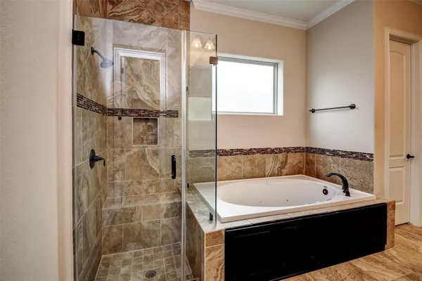 a bathroom with a tub and a shower