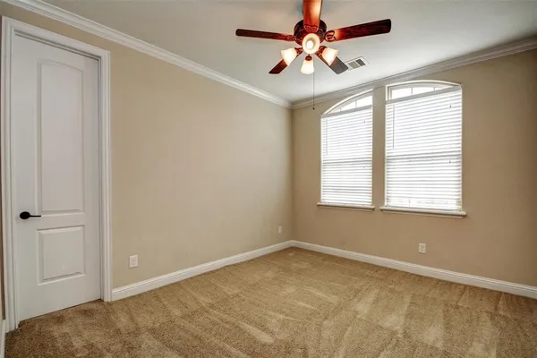 a view of a big room with windows and chandelier fan